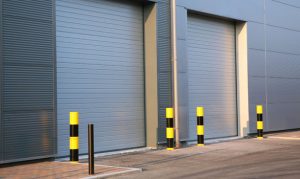 A commercial building with large metal garage doors.