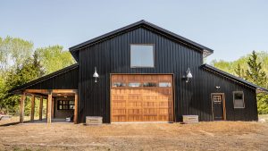 A large residential garage with a rustic wood garage door.
